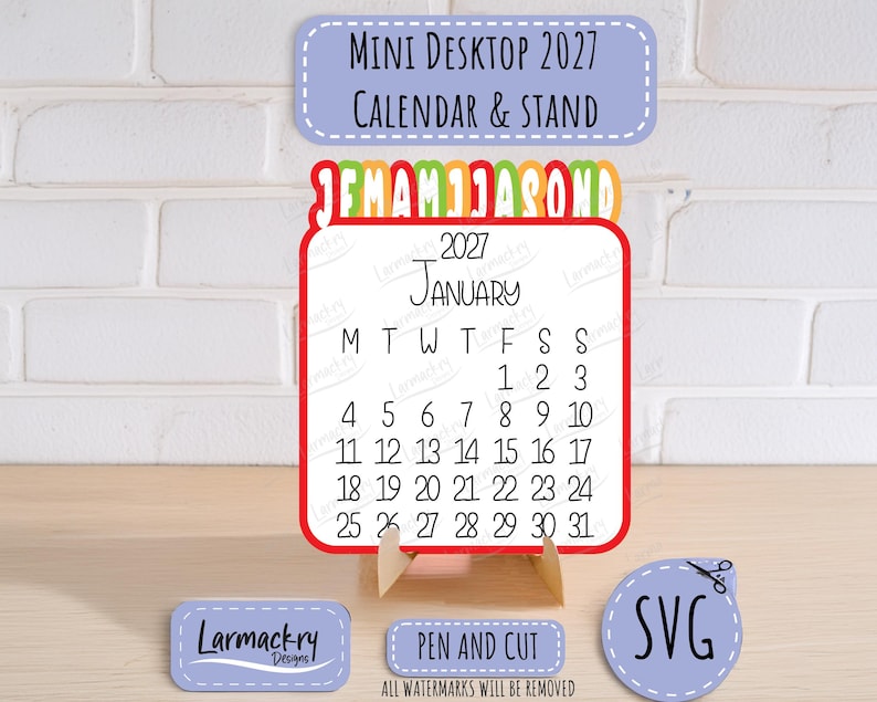May include: A 2027 mini desktop calendar and stand featuring a white card with black text for January, a red border, and a colorful monthly tab header. Includes small labels with the text Mini Desktop 2027 Calendar & Stand, Larmackry Designs, and SVG.
