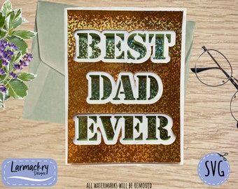 May include: A gold glitter card with the words "BEST DAD EVER" in green letters. The card is on a wooden surface.