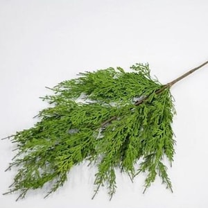 May include: A single artificial cedar sprig with a long, brown stem and green foliage. The sprig is perfect for adding a touch of greenery to your home decor.