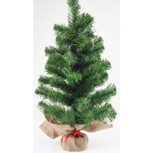 May include: A small, artificial Christmas tree with vibrant green needles. The base is wrapped in burlap and tied with a red ribbon. The tree is a festive decoration for the holiday season.