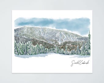 May include: Watercolor print of a snow-covered mountain with ski slopes, evergreen trees, and a cloudy sky. The print is signed "Saddleback" in cursive. The color palette includes shades of blue, green, and white.