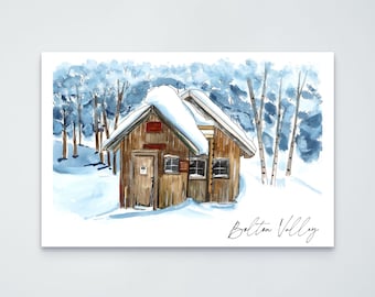 May include: A watercolor illustration of a brown wooden cabin covered in snow, set against a backdrop of blue-toned trees. The roof is heavily blanketed in white snow. The text Bolton Valley is written in black cursive script in the bottom right corner.