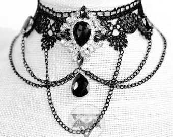 May include: Black lace choker necklace with a large black rhinestone pendant and multiple chain layers. The necklace is on a white mannequin bust. The text "Plamendura Art" and "WGM WORKSHOP" are visible in the image.