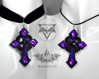 May include: A black choker necklace with a silver chain and a large purple and black cross pendant. The cross has a Celtic knot design and is adorned with purple gems.