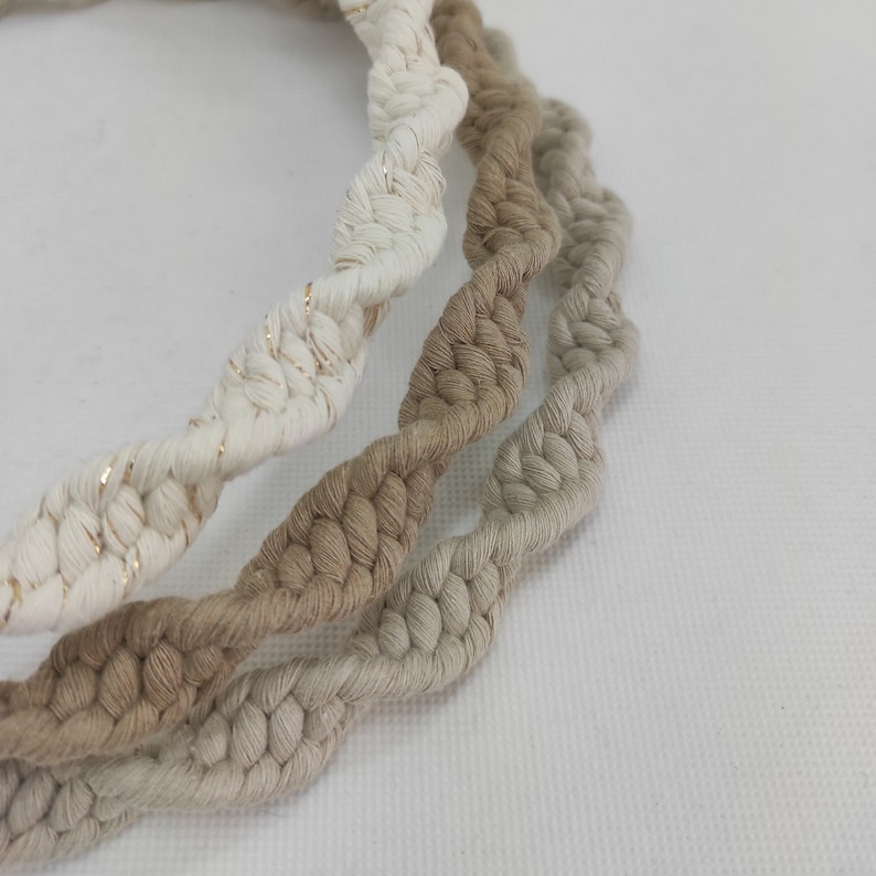 May include: Three braided cords in different shades of beige, white, and cream. The white cord has a subtle gold thread woven into it.
