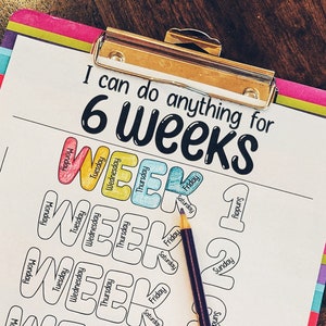 May include: A colorful clipboard with the text "I can do anything for 6 weeks." The clipboard features a weekly goal tracker with spaces for each day of the week. A purple pencil rests on the paper, ready for use.
