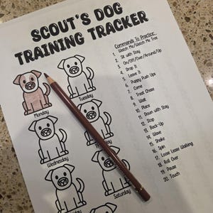 May include: A printed dog training tracker titled "SCOUT'S DOG TRAINING TRACKER" with a list of commands and cartoon dog illustrations. A brown pencil rests on the page, ready for use. The tracker is designed to help track a dog's training progress.