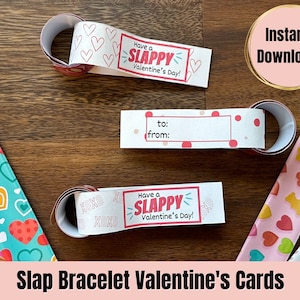 Peut inclure: Cartes de bracelets à claquer pour la Saint-Valentin imprimables avec un motif de cœurs rose et blanc, un motif de beignets rose et bleu et un motif d'oursons en gélatine rose et jaune. Les cartes disent "Have a Slappy Valentine's Day!" et ont un espace pour écrire "to:" et "from:".