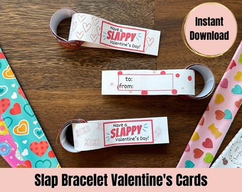 May include: Printable Valentine's Day slap bracelet cards with a pink and white heart pattern, a pink and blue donut pattern, and a pink and yellow gummy bear pattern. The cards say "Have a Slappy Valentine's Day!" and have a space to write "to:" and "from:".