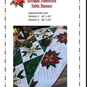 May include: A quilted table runner with a poinsettia design. The runner features a white background with green and red poinsettia patterns. Approximate sizes are 40.6cm x 114.3cm and 45.7cm x 132.1cm. The text "Scrappy Poinsettia Table Runner" is visible.