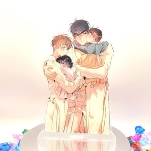 May include: An acrylic stand featuring an illustration of three figures embracing, with a child being held. The figures are depicted in a soft, colorful style. The stand is on a rotating platform surrounded by colorful, faceted gems.