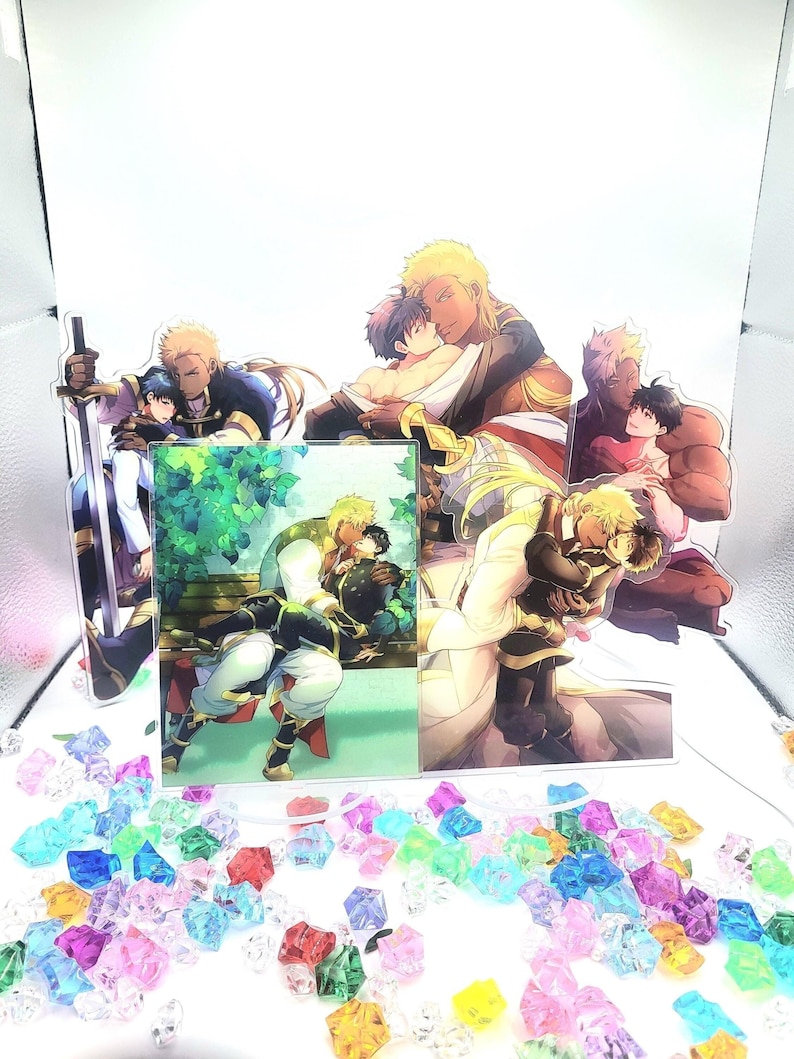 May include: Four acrylic stands featuring anime characters. The stands are clear and show different scenes of two characters embracing. The characters are drawn in a colorful anime style.