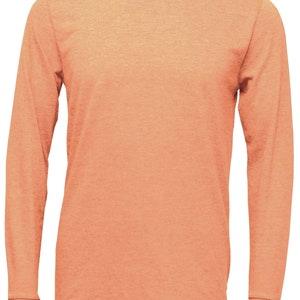 May include: A long-sleeved t-shirt in a peachy orange color. The shirt is made of a soft, comfortable fabric and has a relaxed fit.