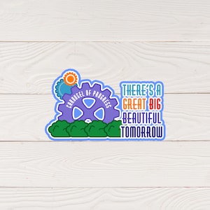 May include: A colorful sticker featuring a purple gear with the words "Carousel of Progress." The sticker also includes the phrase "There's a Great Big Beautiful Tomorrow" in various colors, with green bushes at the bottom.