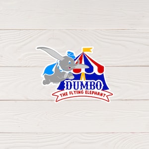 Puede incluir: Una pegatina con Dumbo, el elefante volador. El elefante gris se representa en pleno vuelo con una capa y un sombrero azules, sobre un fondo de carpa de circo. El texto "Dumbo The Flying Elephant" se muestra en negrita.