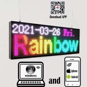 May include: A black LED sign with the text "2021-03-26 Hi. Rainbow" displayed in rainbow colors. The sign is hanging from a chain and can be controlled by a smartphone or computer.