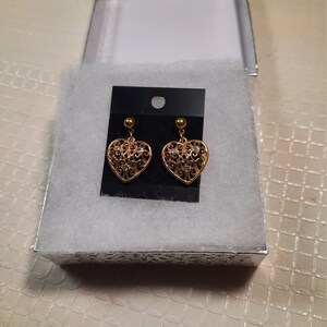 Heart earrings in gold tone with cubic zirconia stud clasp.