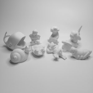May include: A set of nine white ceramic animal figurines, including a whale, snail, turtle, frog, and a unicorn. The figurines are all in a simple, unpainted style, ready to be decorated.