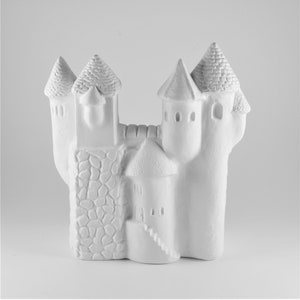 May include: White ceramic castle figurine with multiple towers and a stone wall detail.