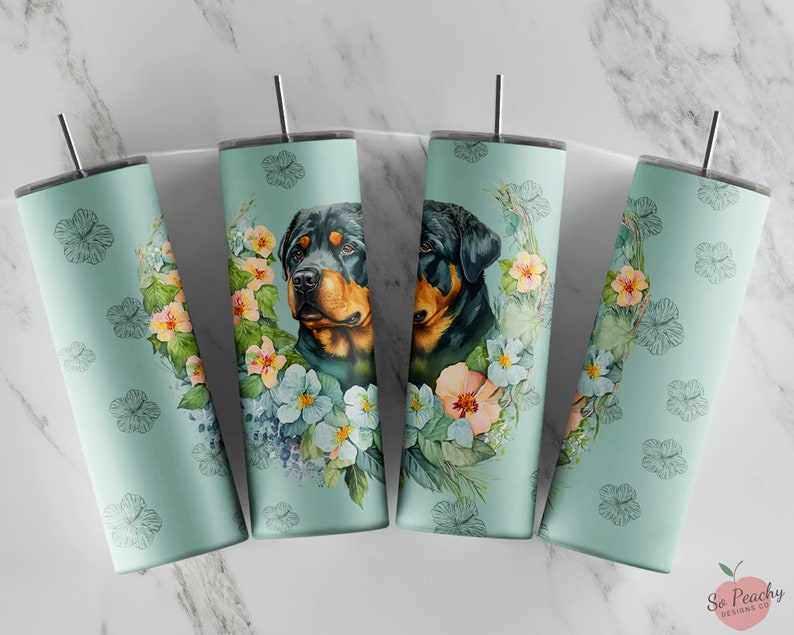 May include: Four stainless steel tumblers with a light blue background and floral designs. Each tumbler features a Rottweiler dog with a floral wreath around its head.