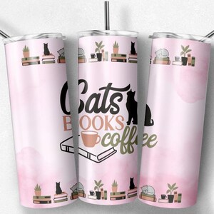 May include: A pink stainless steel tumbler with a design of cats, books, and coffee. The tumbler has a black and white illustration of a cat reading a book with a cup of coffee. The text "Cats Books Coffee" is written in a stylized font.