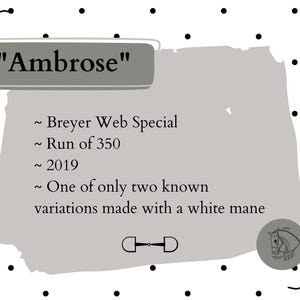 May include: A rectangular informational card with a white background featuring black polka dots and decorative corner ribbons. The text reads: "Ambrose", "~ Breyer Web Special", "~ Run of 350", "~ 2019", and "~ One of only two known variations made with a white mane."