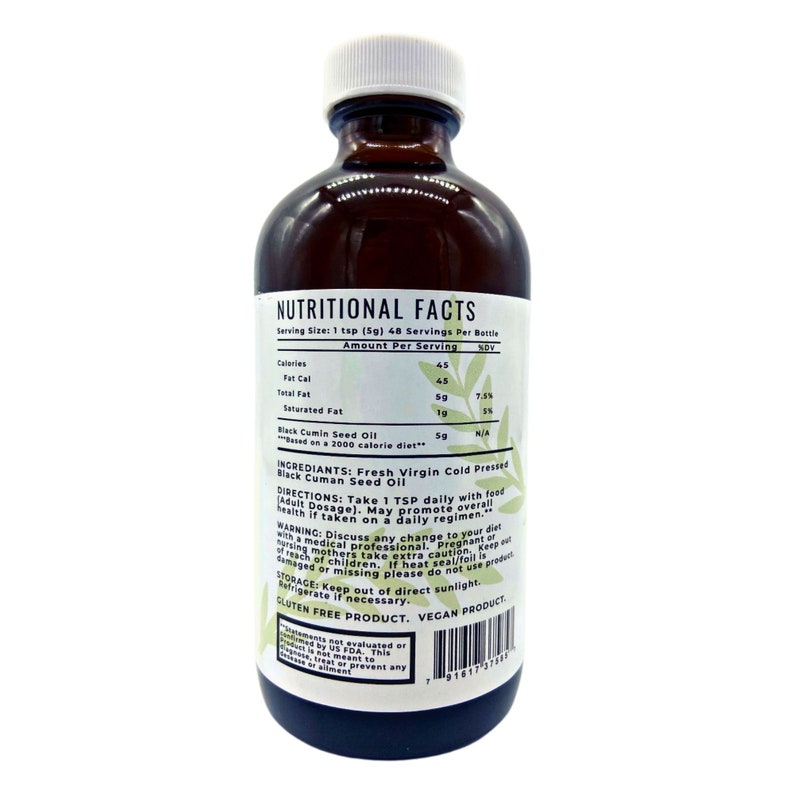 May include: A brown glass bottle of Black Cumin Seed Oil with a white label. The label includes nutritional facts, ingredients, directions, and warnings. The bottle is labeled as gluten-free and vegan.