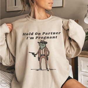 Hold On Partner I'm Pregnant Sweatshirt Funny Pregnancy Reveal Shirt Cowboy Frog Pregnancy Announcement Meme Maternity Gift Expecting Baby image 1