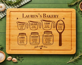 May include: A rectangular bamboo cutting board featuring a laser-engraved conversion chart. The text reads Lauren's Bakery and bake with love. Graphics include measuring cups, a tablespoon, and jars with volume conversions in cups, ounces, and milliliters.
