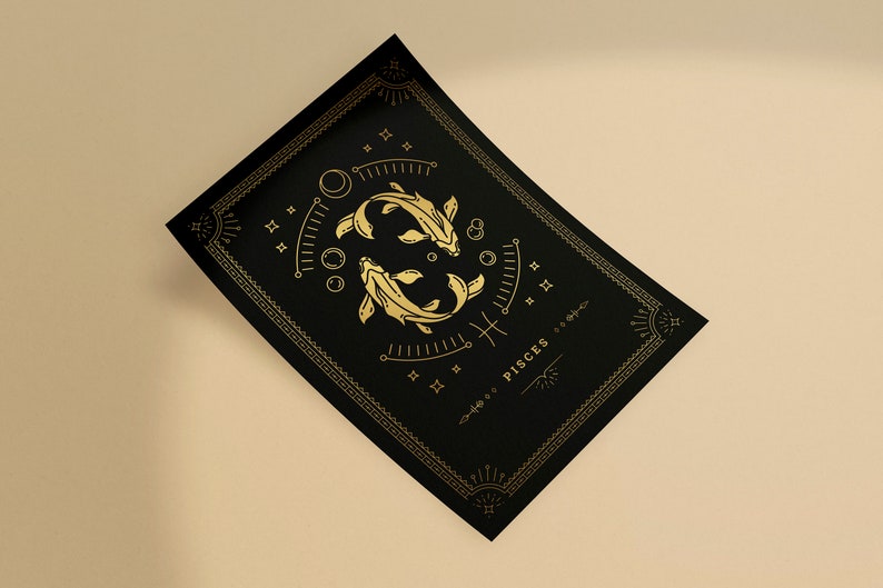 May include: A black and gold print with a stylized illustration of two fish, the astrological symbol for Pisces, and the word "Pisces" in gold lettering.