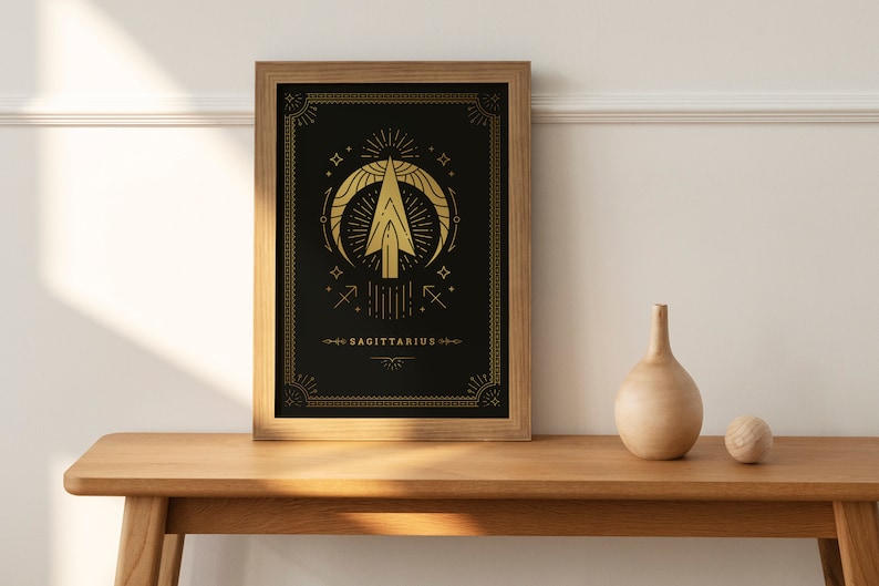 May include: A framed print with a gold design of the Sagittarius zodiac symbol on a black background. The text "SAGITTARIUS" is at the bottom of the print.