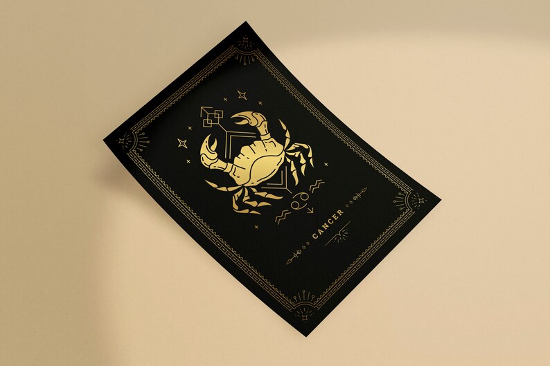 May include: A black and gold zodiac print featuring the Cancer constellation with a crab illustration and the word "CANCER" in a decorative font.