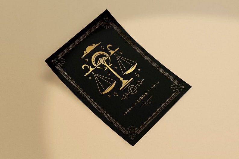 May include: Black rectangular card with a gold Libra zodiac design. The design features a scale, crescent moon, stars, and the word "LIBRA". The card has a decorative gold border and is set against a neutral background.