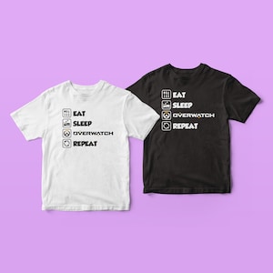 May include: Two t-shirts with a list of activities: Eat, Sleep, Overwatch, Repeat. The white t-shirt has black text and the black t-shirt has white text.