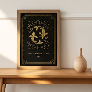 May include: A framed print with a black background and gold accents. The print features a stylized illustration of two fish, the astrological symbol for Pisces, and the word "Pisces".