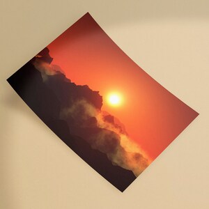 May include: A print depicting a sunset over a mountain range. The sky transitions from a bright orange near the sun to a darker red. The mountains are silhouetted, with clouds and mist adding depth to the scene.