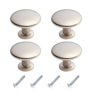 May include: Set of four brushed nickel cabinet knobs with a round shape and a smooth finish. The knobs come with four matching screws.