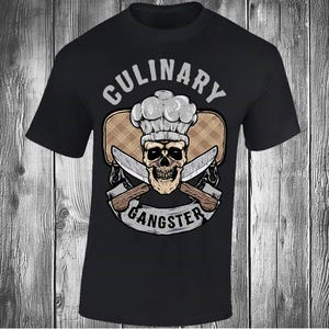 May include: Black t-shirt with a graphic design featuring a skull wearing a chef's hat, crossed knives, and the words "CULINARY GANGSTER" in a banner. The design has a vintage, tattoo-inspired aesthetic.