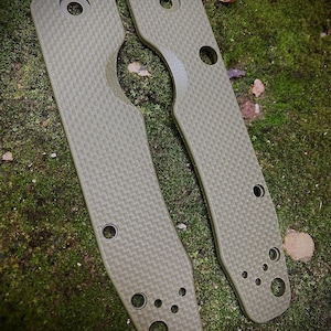 May include: Two green carbon fiber knife scales with rounded edges and multiple holes.