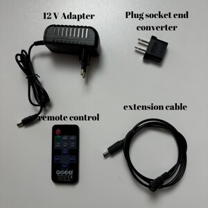 May include: A black 12V adapter with a power cord, a black plug socket end converter, a black extension cable, and a black remote control with buttons for speed, mode, and brightness.