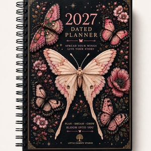 May include: A black spiral-bound 2027 dated planner featuring pink and cream butterfly illustrations, floral accents, and gold text that reads 2027 DATED PLANNER, SPREAD YOUR WINGS LIVE YOUR STORY, PLAN DREAM GROW BLOOM INTO YOU, and LITTLE CANOPY STUDIO.