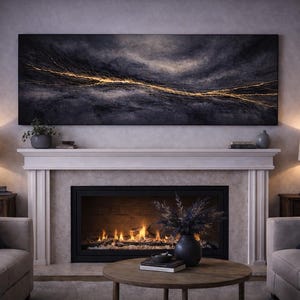 May include: A living room scene featuring a fireplace with a lit fire, flanked by two armchairs and side tables with lamps. Above the fireplace is a large abstract painting in dark blues and gold. A coffee table with decor sits in front.