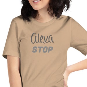 May include: A tan t-shirt with the text "Alexa STOP" in gray lettering.