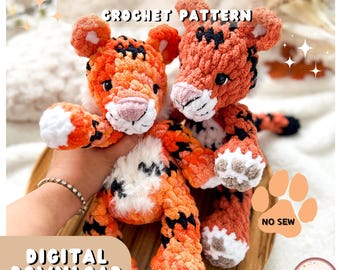 May include: Two crocheted tiger plushies in orange, black, and white. The text "TORI THE TIGER CROCHET PATTERN" is at the top. The words "DIGITAL DOWNLOAD" are at the bottom. The plushies have a pink nose and black eyes. The plushies are on a wooden tray.