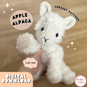 May include: A white crochet alpaca plushie with black eyes and a small black 'Y' shaped mouth. The plushie has a fluffy texture and is labeled "APPLE ALPACA" and "CROCHET PATTERN". The image also includes the text "Low sew" and "DIGITAL DOWNLOAD".