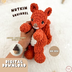 May include: A rust-orange crochet squirrel plush toy with a white belly, dark eyes, and a small brown nose. Text reads: NUTKIN SQUIRREL, ACORN ACCESSORY INCLUDED, NO-SEW, DIGITAL DOWNLOAD. The squirrel is shown with a small brown and tan crochet acorn.