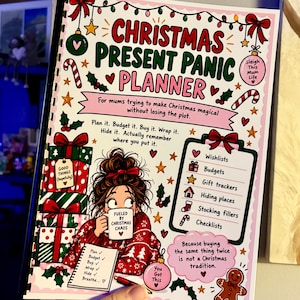 May include: A spiral-bound Christmas Present Panic Planner with a white cover featuring colourful holiday illustrations, including stacked gift boxes, a gingerbread man, and a cartoon character holding a mug that reads Fueled by Christmas Chaos.