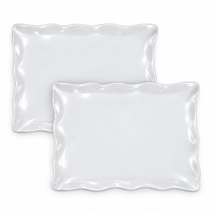 May include: Two rectangular white serving platters with a glossy finish and a distinct wavy, scalloped edge design. The platters are stacked slightly offset from one another, showcasing a smooth, reflective surface and a uniform white color.