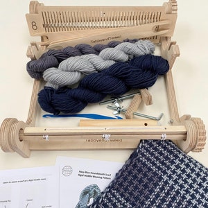 May include: A wooden rigid heddle loom with yarn in various shades of blue and grey, along with weaving tools and instructions for making a houndstooth scarf. The instructions include a diagram of the loom and its parts.