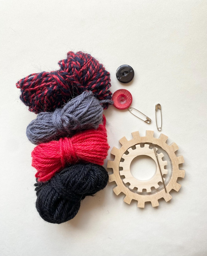 red and black  yarn, wooden flower looms, needle and buttons
